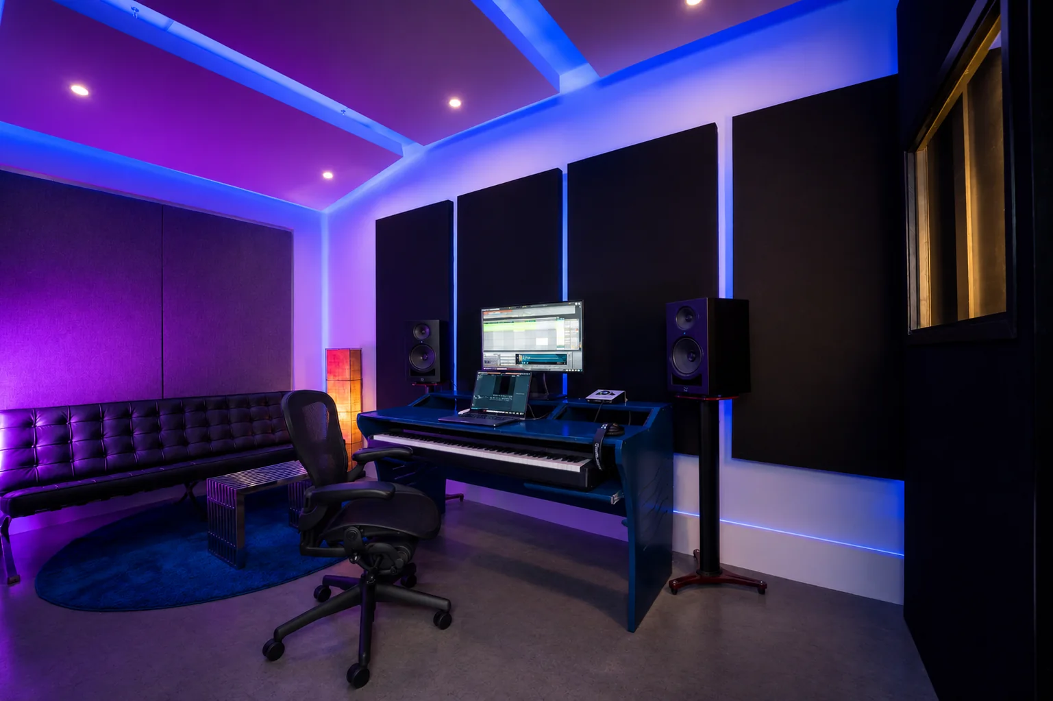 Wide view of Studio B with workstation, monitors and acoustic panels