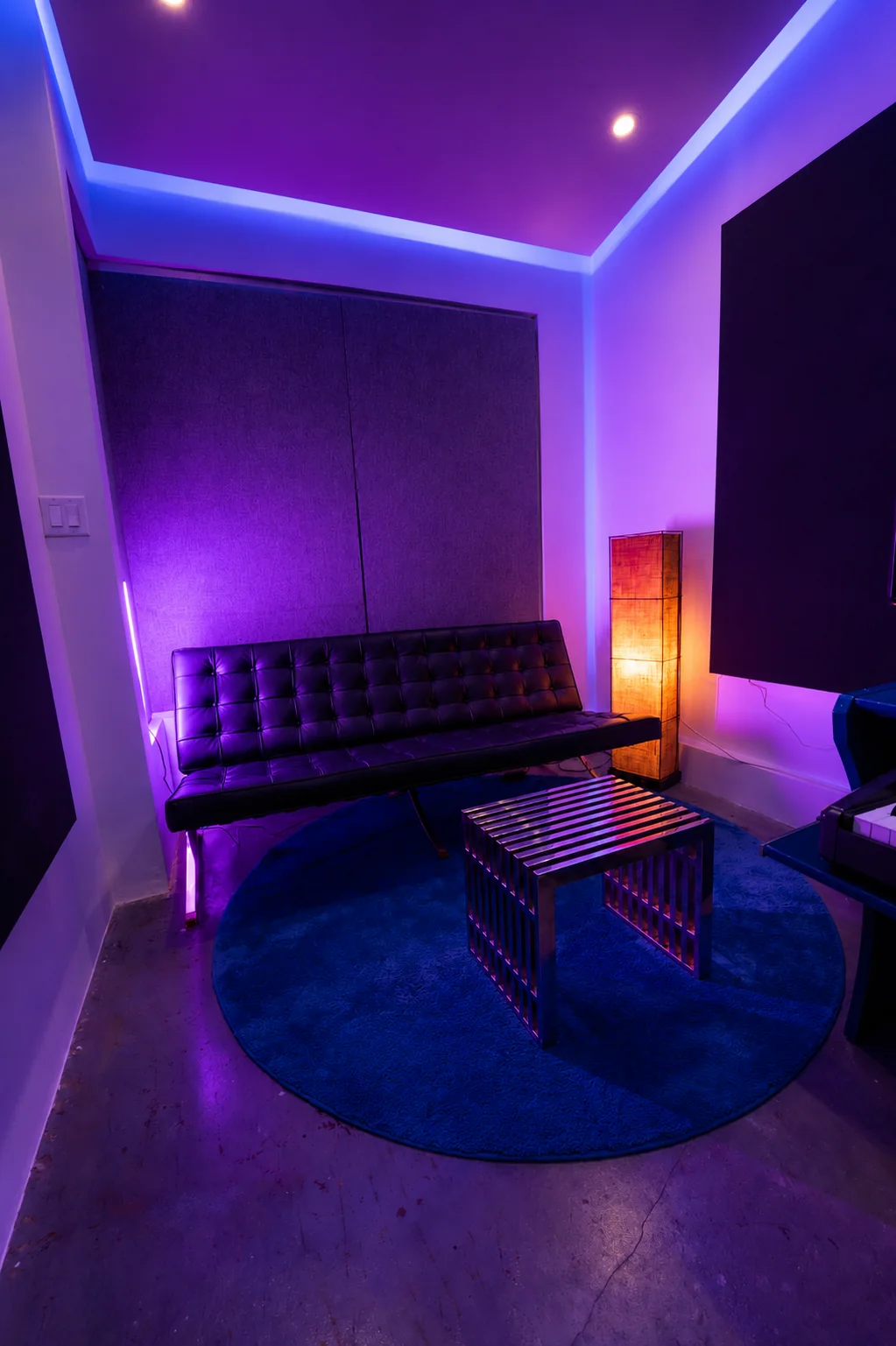 Studio B lounge seating under purple ambient lighting