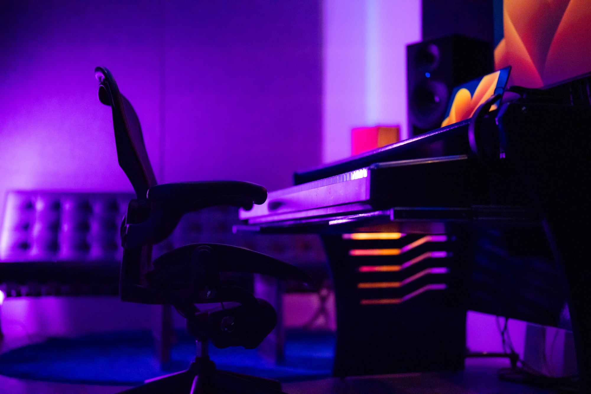 Atmospheric view of the Studio B production desk under purple lighting